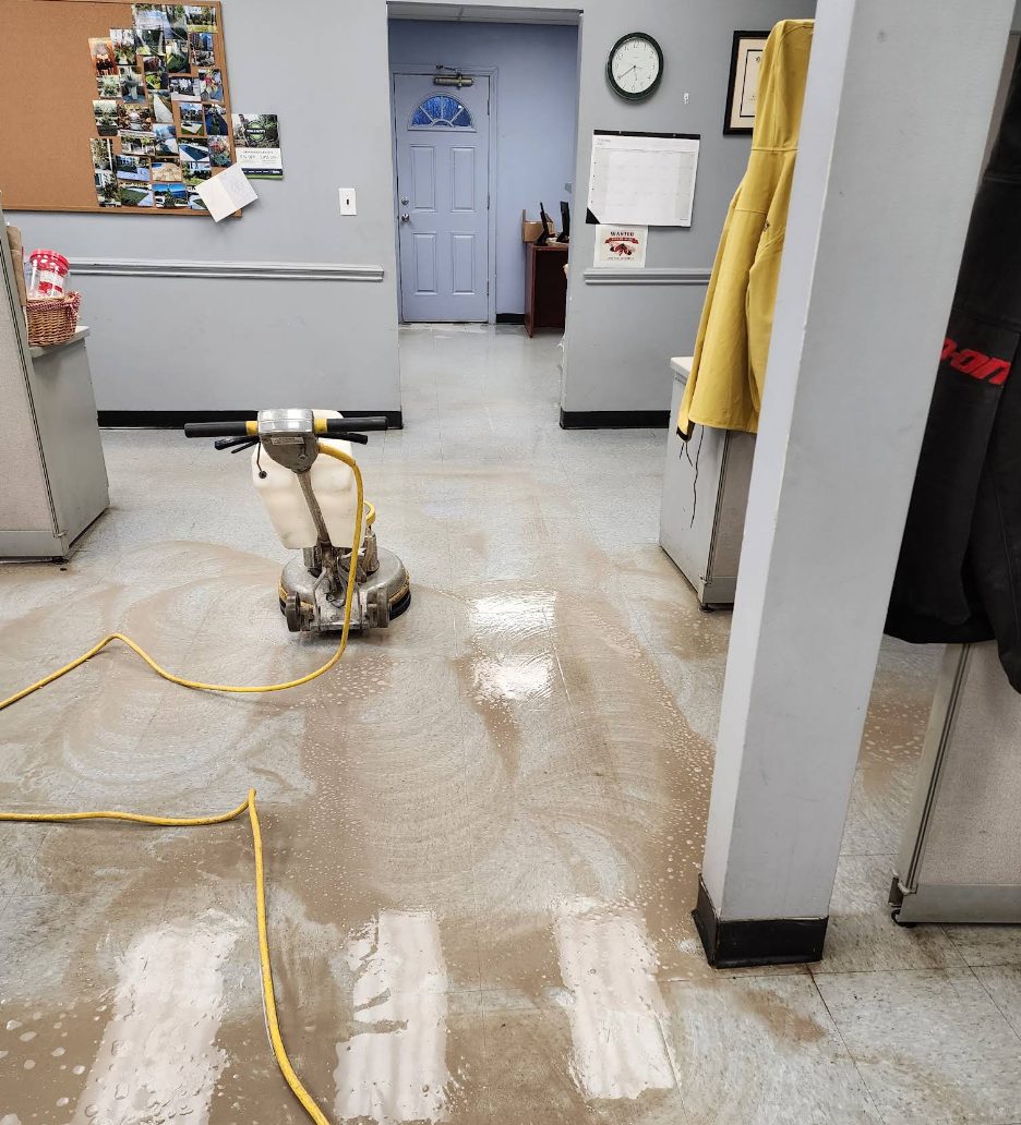 Commercial floor scrubbing and recoat in progress